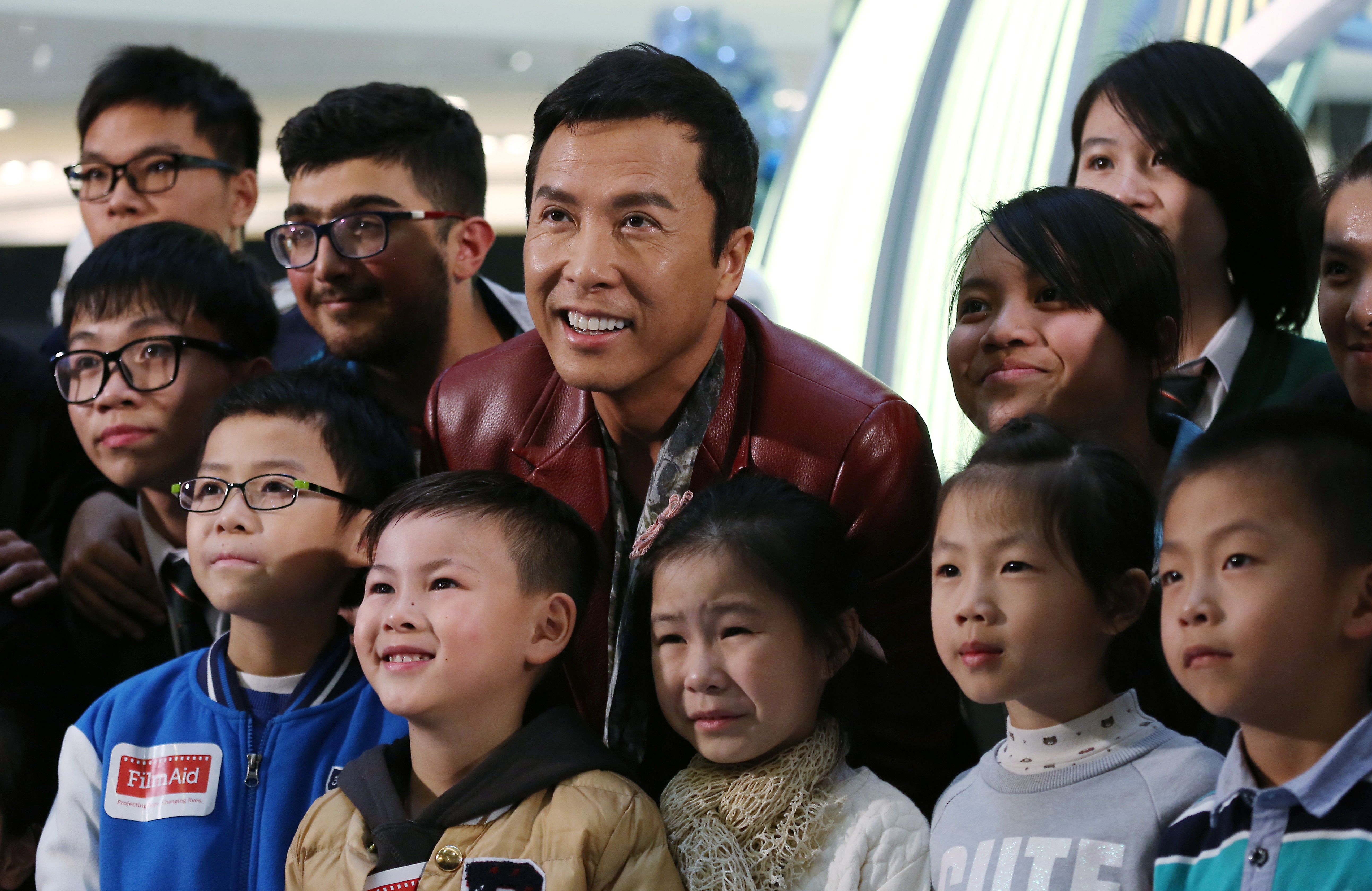 Actor Donnie Yen Ji-dan (centre) and fans pose for a photo at the premiere of Rogue One: A Star Wars Story, in Mong Kok last December. The Chicken Soup Foundation treated 300 underprivileged children to the premiere. Photo: Jonathan Wong