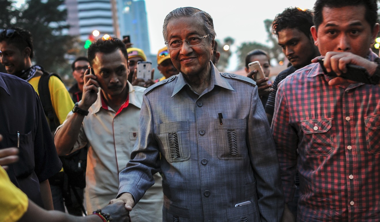 Former Malaysian prime minister Mahathir Mohamad (centre) is known to wear safari suits on informal occasions. Picture: AFP