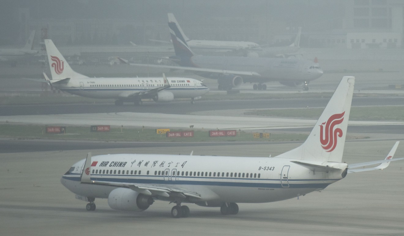 Planes wait to take off on a polluted day at Beijing airport early this month. Photo: AFP