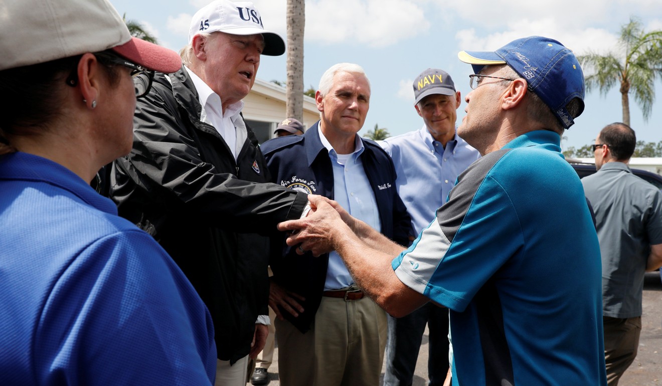 US President Donald Trump (2ndL) shakes the hand of a resident in Florida while inspecting the damage inflicted by Hurricane Irma. Photo: Reuters