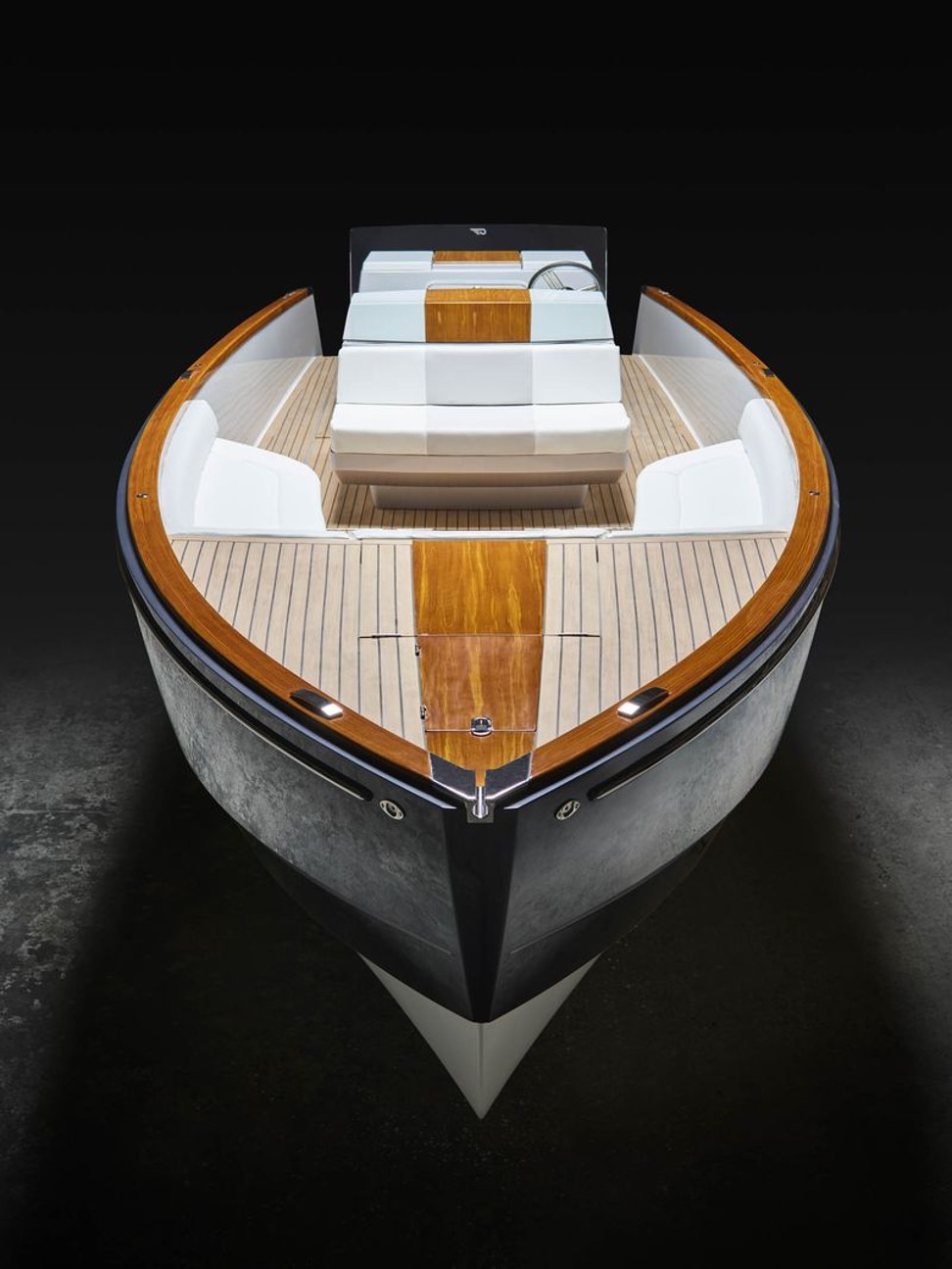 Dasher makes use of a light-weight synthetic teak for the decking (the lighter colored “wood” seen here) and its trademarked Artisanal Teak for the glossy trim.