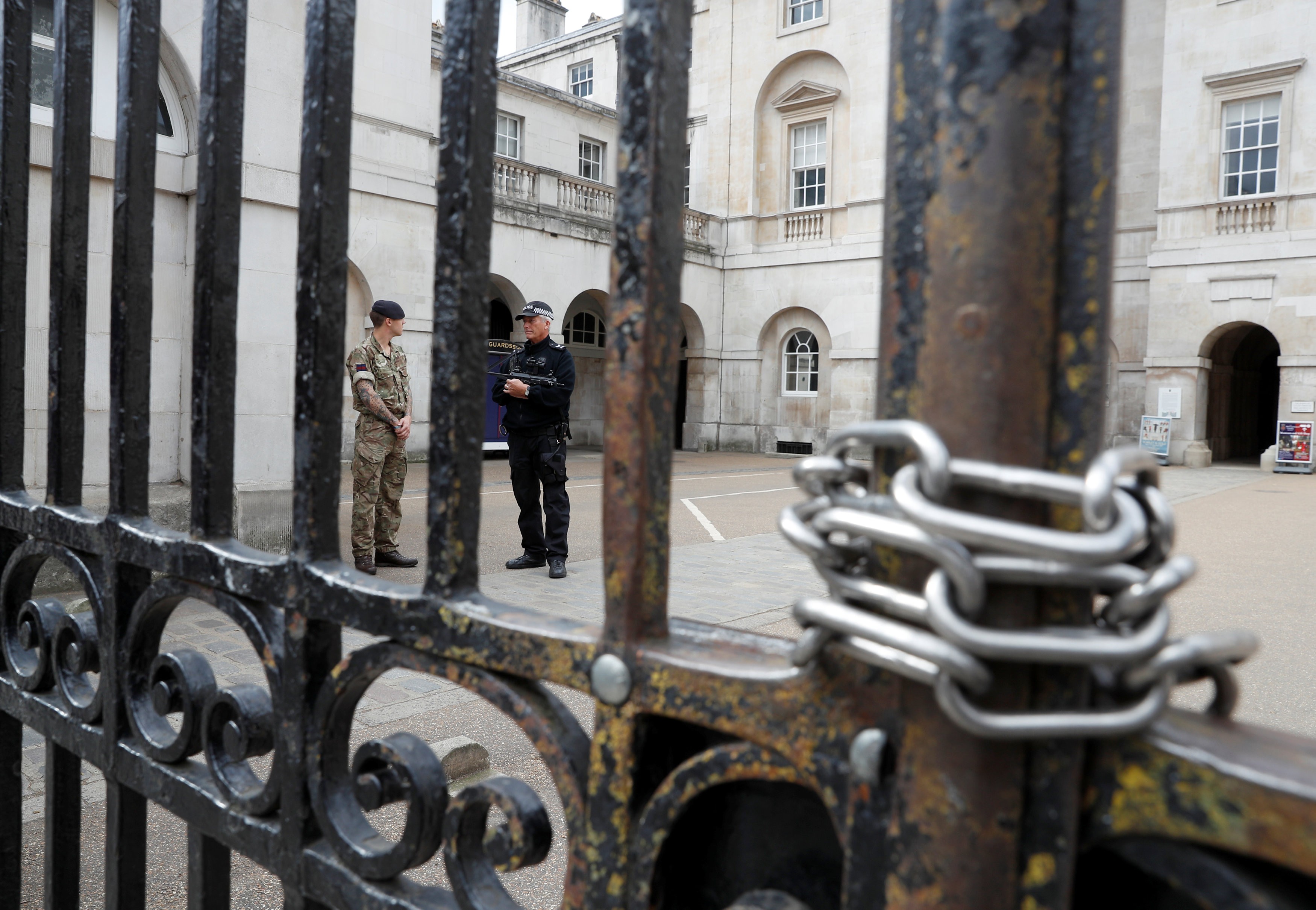 A police officer and a soldier stand at the entrance to Horse Guards Parade after it was closed because of the heightened security following an explosion on an underground train on Friday in London. Photo: Reuters