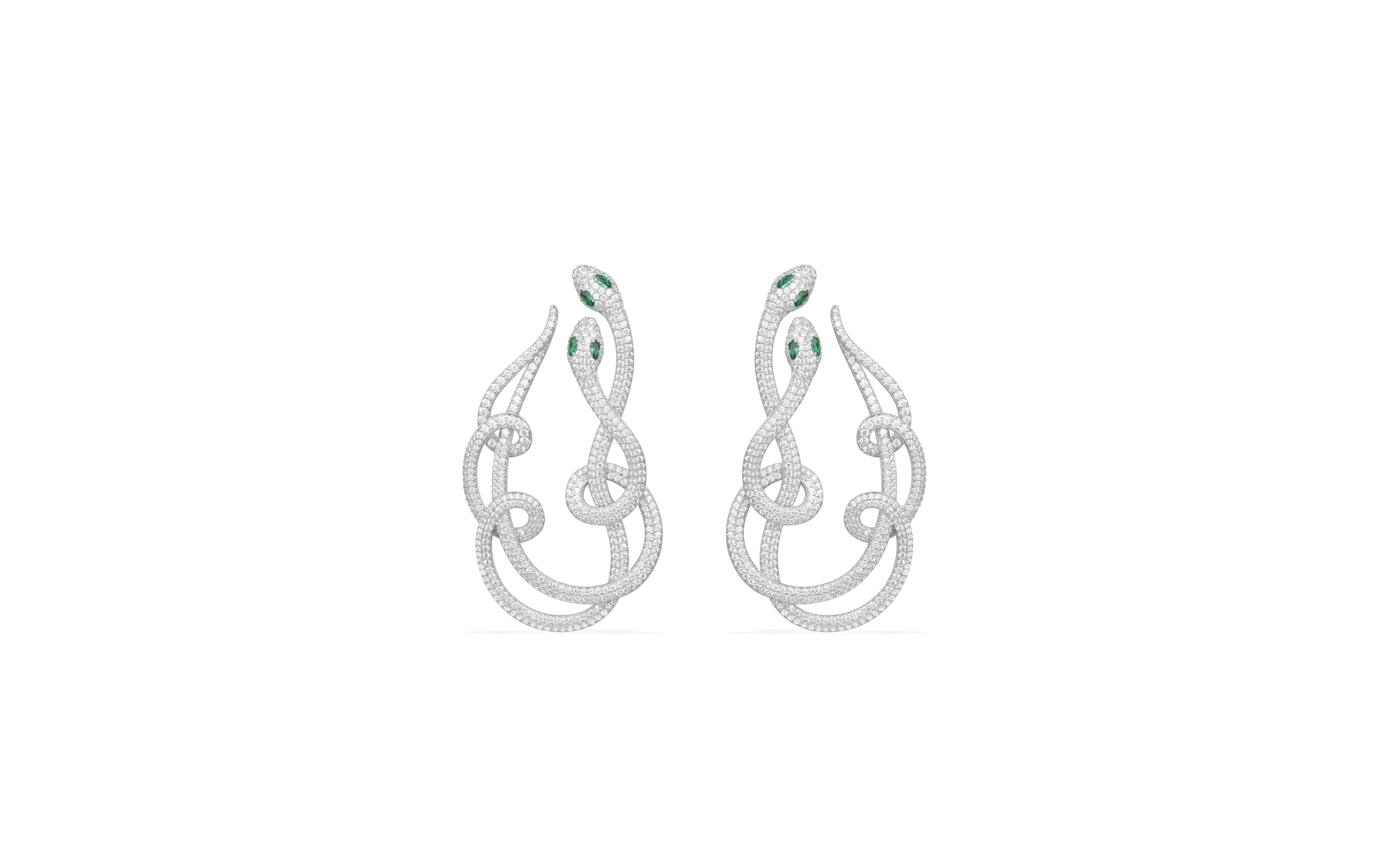 Make a statement with the serpentine earrings from APM Monaco and the embroidered dress by Needle & Thread