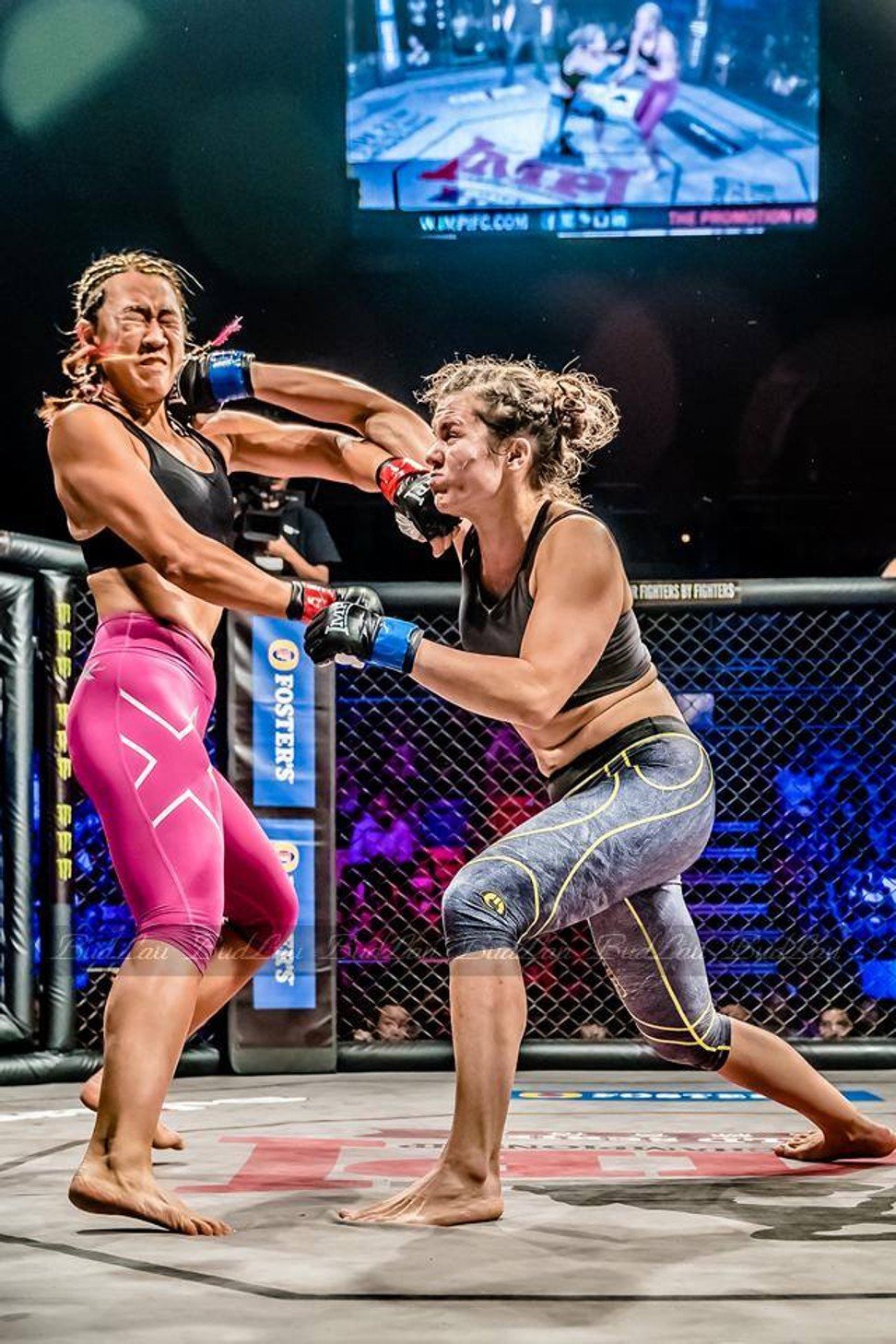 Carder (right) lands a blow on Tricia Yap in the first professional women’s cage fight held in Hong Kong – part of the IMPI2 World Series (Asia) – at Queen Elizabeth Stadium in 2015.