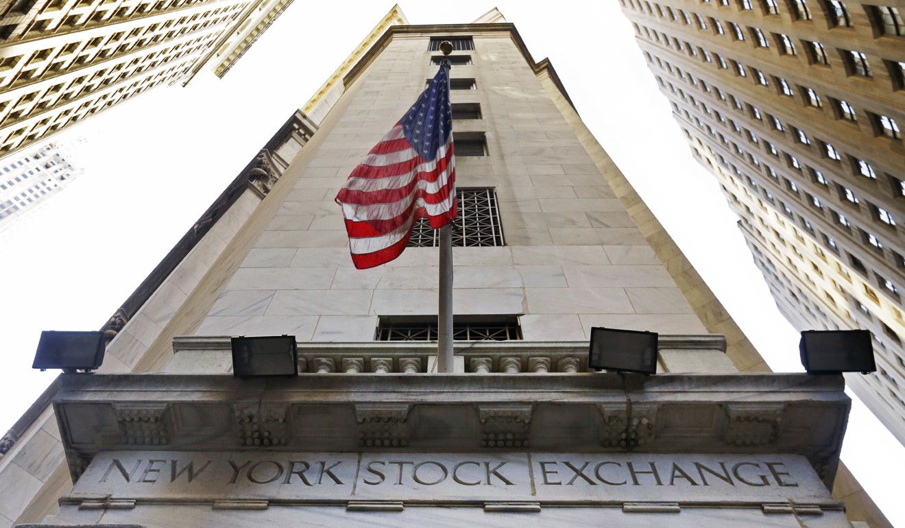 The American flag flies above the Wall Street entrance to the New York Stock Exchange. Photo: AP