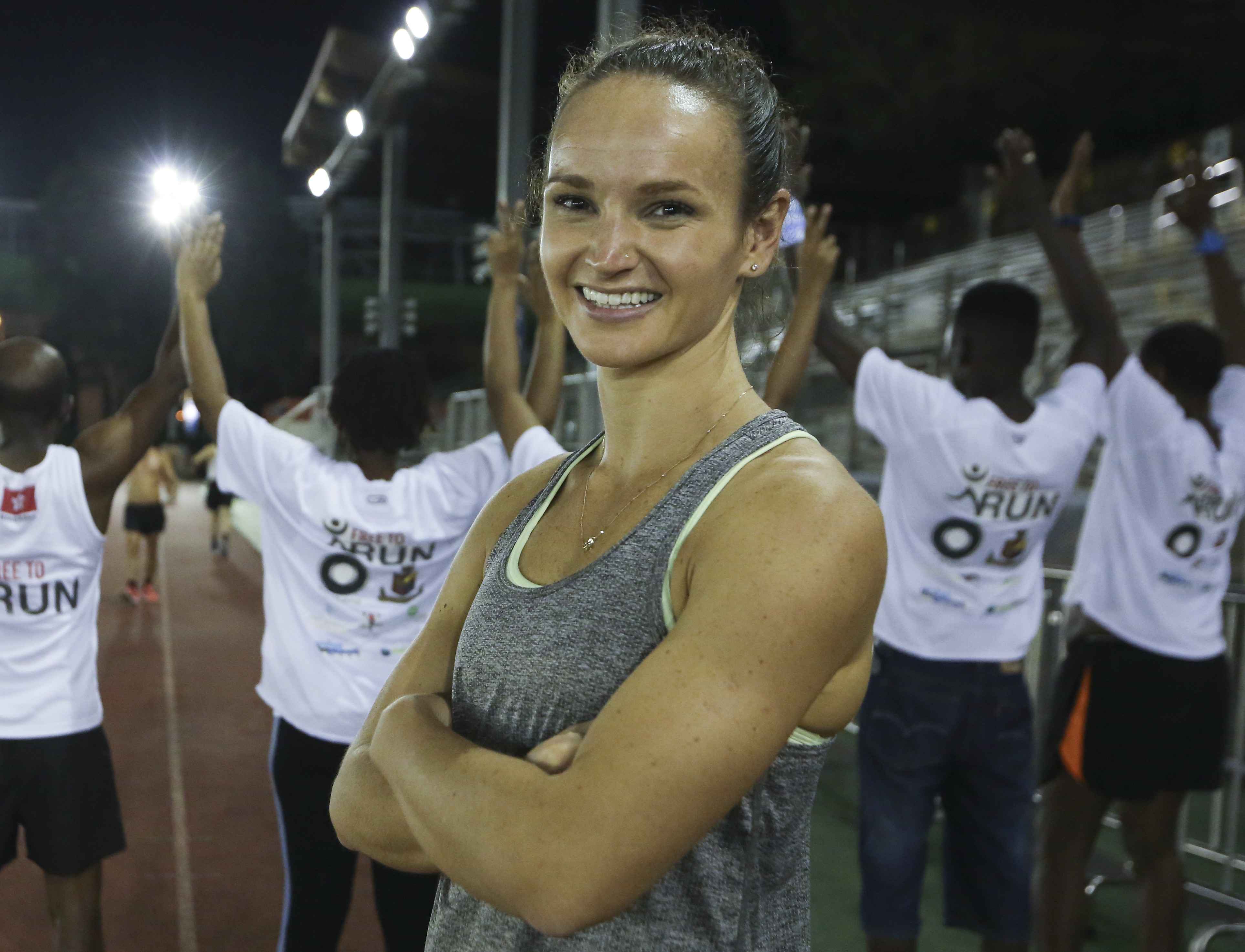 Mai Schroder, a PE teacher and volunteer for Free to Run, with Hong Kong refugees at a Free to Run training session at Aberdeen Sports Ground. Photo: Edmond So