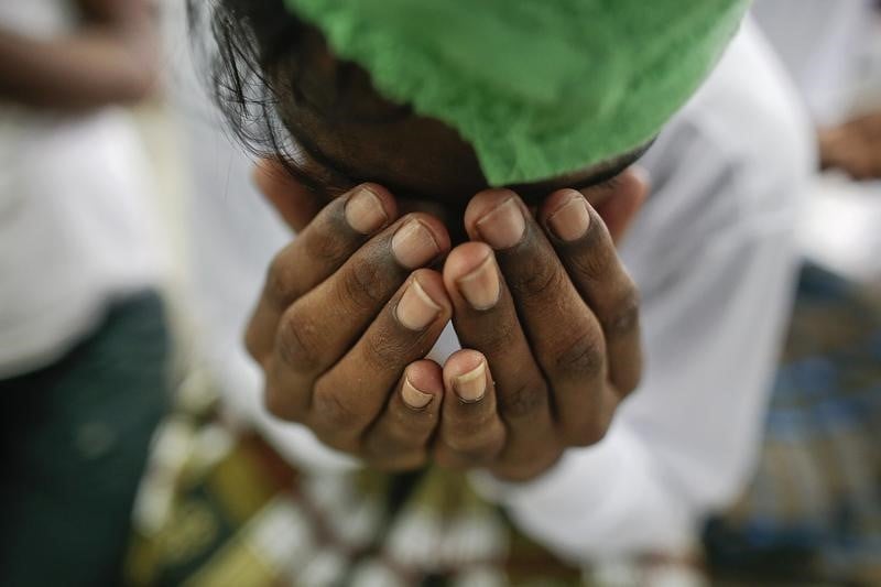 A suspected victim of human trafficking prays at a government shelter in the Takua Pa district of Phang Nga, Thailand, in October 2014. Photo: Reuters