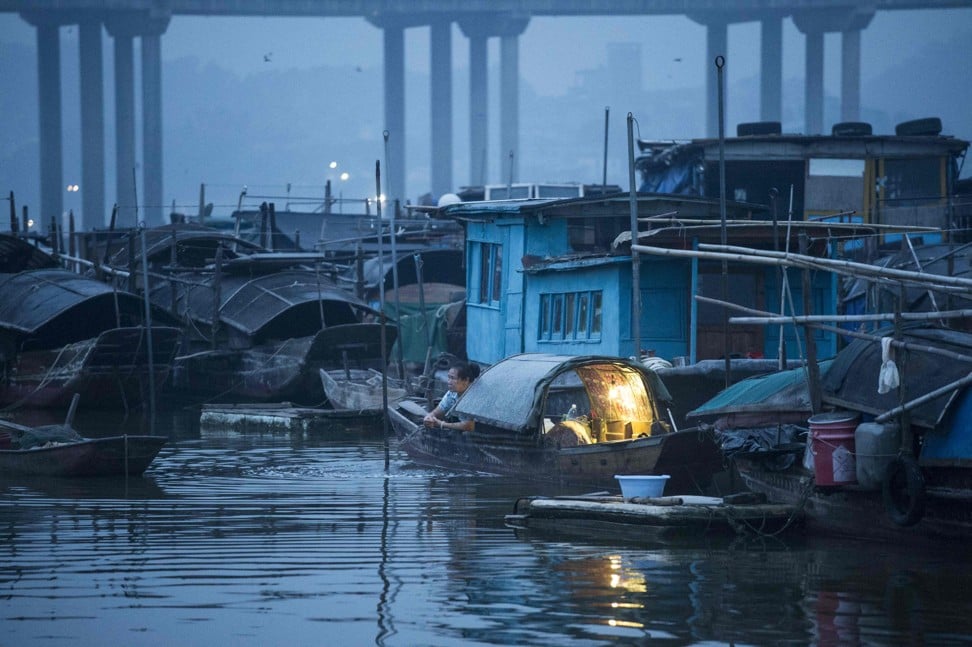 A woman on her boat after waking up in Datang. Photo: AFP