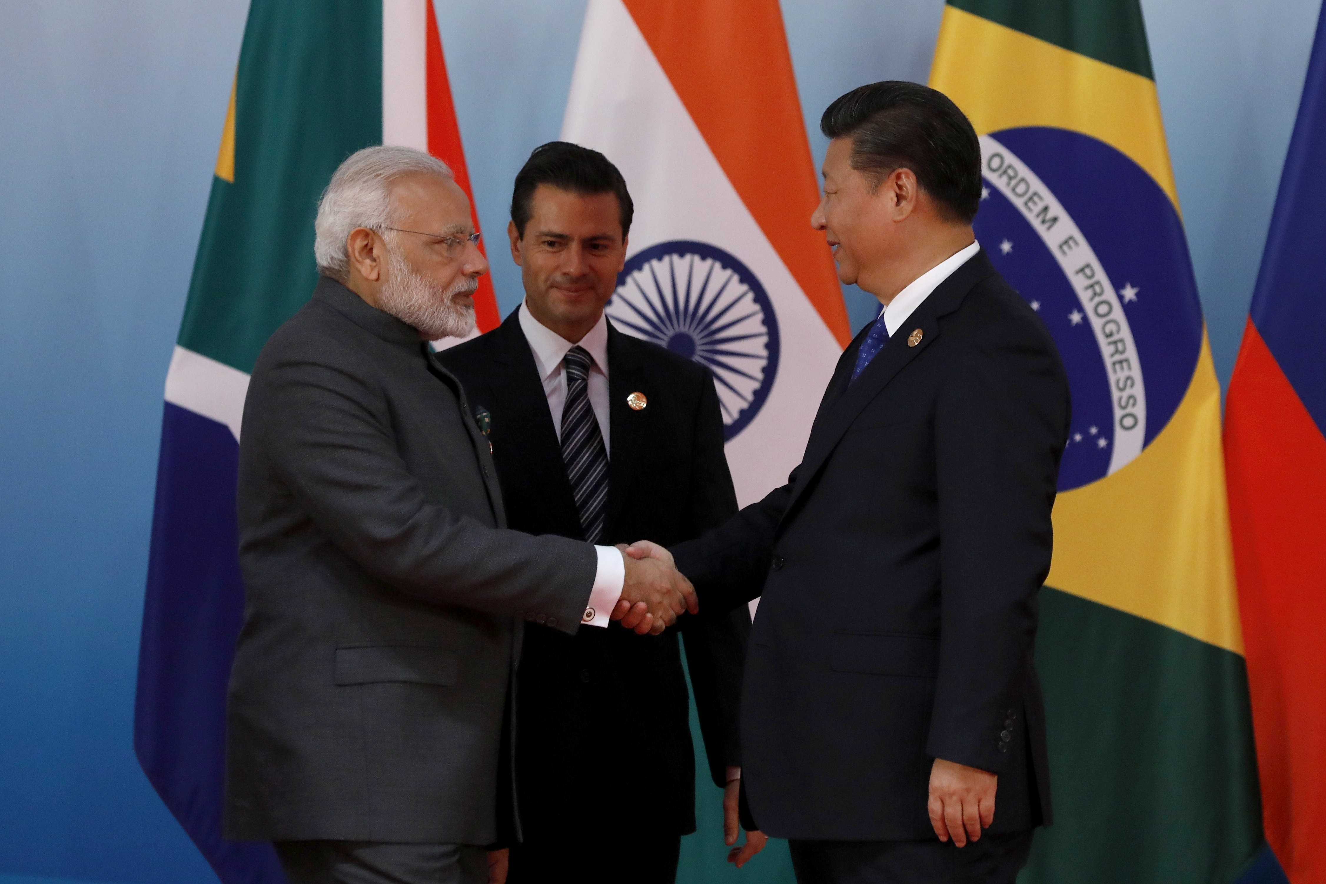 Chinese President Xi Jinping (right) greets Indian Prime Minister Narendra Modi and Mexico's President Enrique Pena Nieto before a group photo session on the sidelines of the 2017 BRICS Summit in Xiamen, China, on September 5. Photo: EPA-EFE