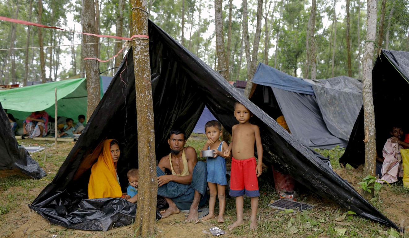 Rohingya refugees from Myanmar's Rakhine state shelter under makeshift tents after arriving at a refugee camp near the Bangladeshi town of Teknaf. Photo: AFP