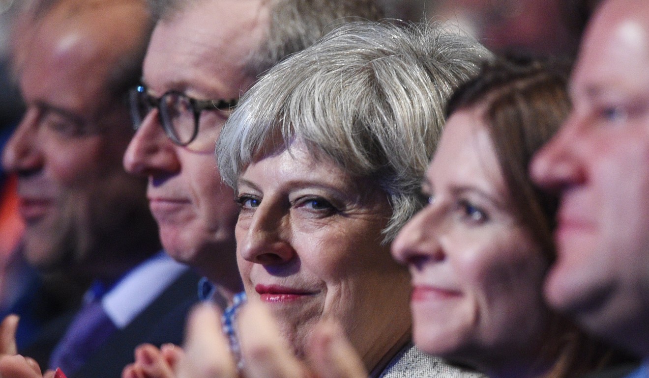 British Prime Minister Theresa May (centre) and her husband Philip (centre right) attend the first day of Conservative Party Conference in Manchester on Sunday. Photo: EPA