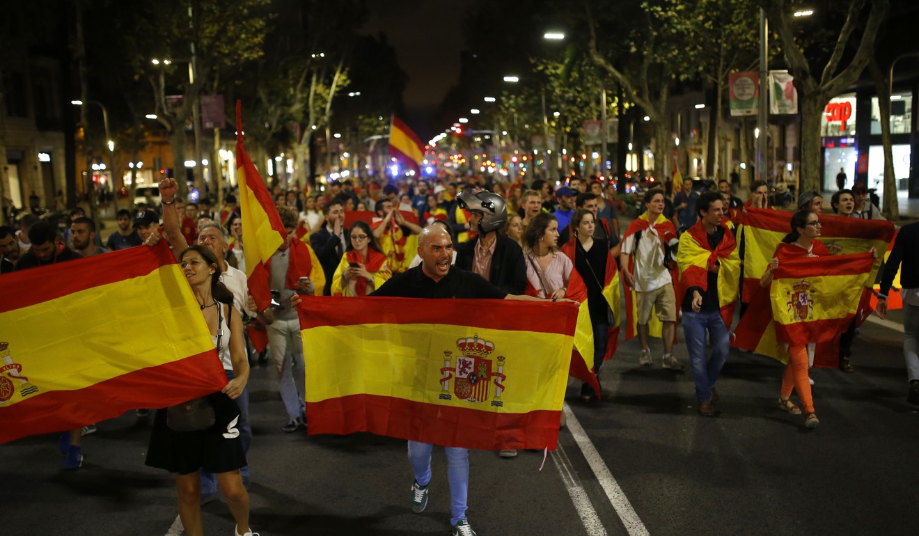 Anti-independence demonstrators waving Spanish flags during a protest in Barcelona on Wednesday. Photo: AP