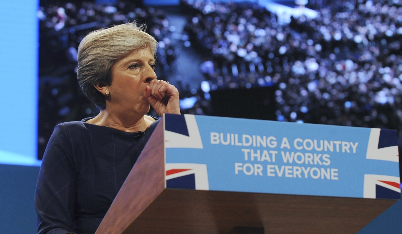 Conservative Party leader and British Prime Minister, Theresa May, coughs during her address at the Conservative Party conference in Manchester. Photo: AP