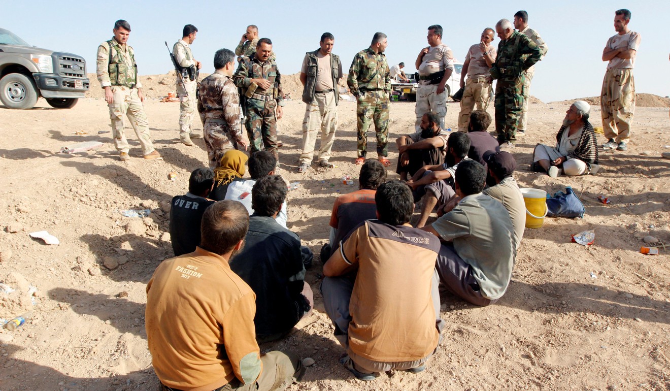 Kurdish Peshmerga forces detain Islamic State militants southwest of Kirkuk. Photo: Reuters
