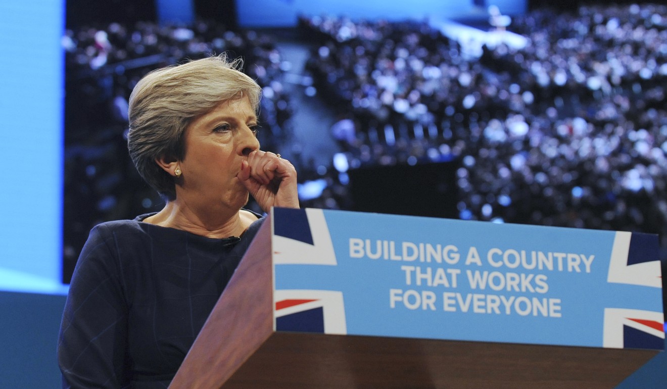 Prime Minister Theresa May coughs during her address to delegates at the Conservative Party Conference in Manchester. Photo: AP