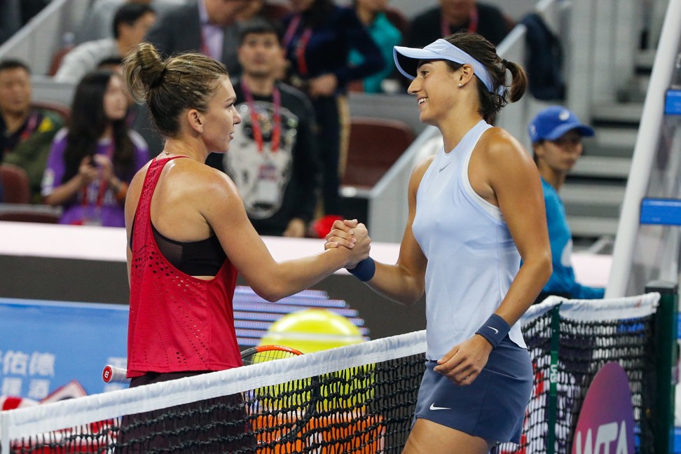 Caroline Garcia greets new world number one Simona Halep at the net after defeating her in the China Open final. Photo: EPA