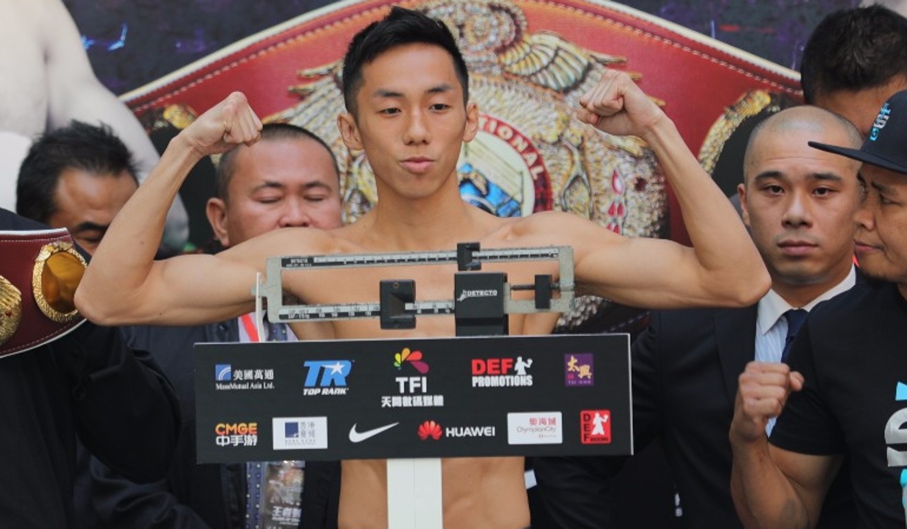 Rex Tso flexes his muscles after making weight.