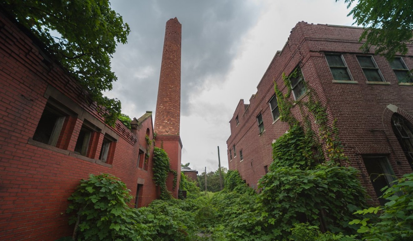One of the first buildings I saw was the morgue (right). The fractured chimney of a coal-fired boiler room (left) is also visible from miles away.