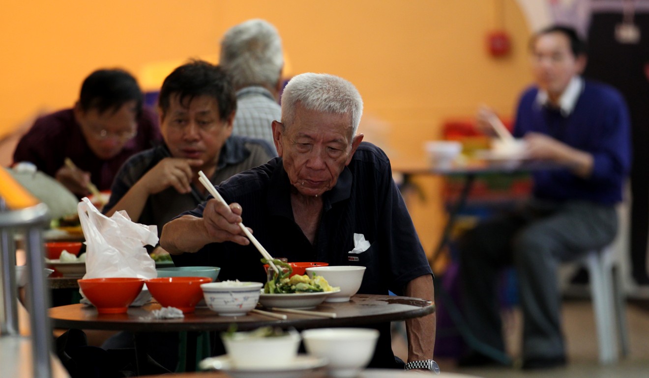 Customers eat lunch at a HK$20 buffet food stall in San Po Kong. More than 70,000 families residents survive on less than HK$15 a meal per person. Photo: Nora Tam