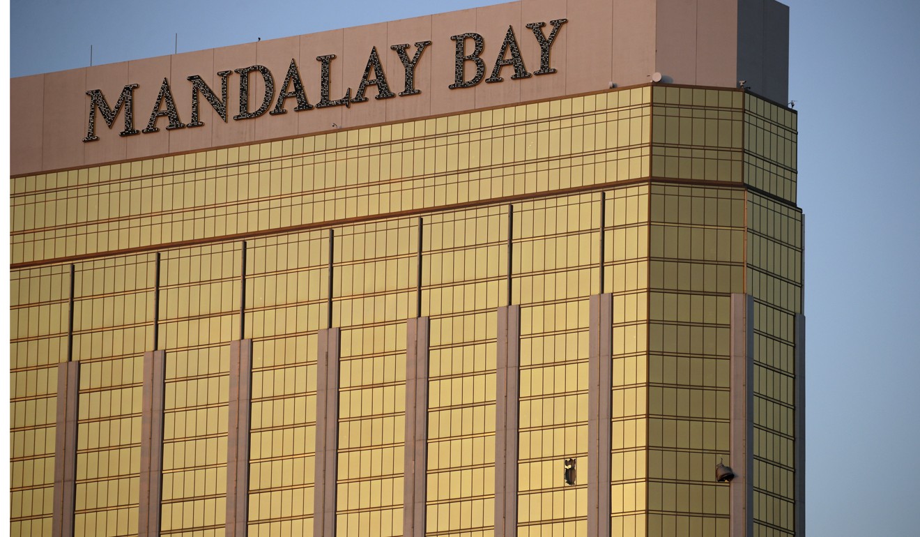 In this October 2 file photo, drapes billow out of broken windows (bottom left) at the Mandalay Bay resort and casino on the Las Vegas Strip. Photo: AP