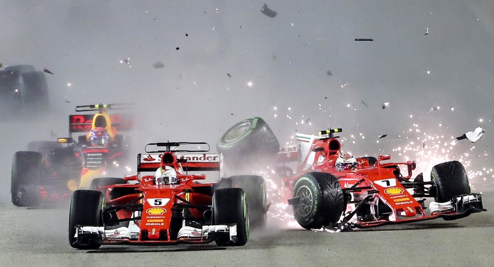 Vettel (L) and Finnish teammate Kimi Raikkonen collide at the start of the Singapore Grand Prix. Photo: EPA
