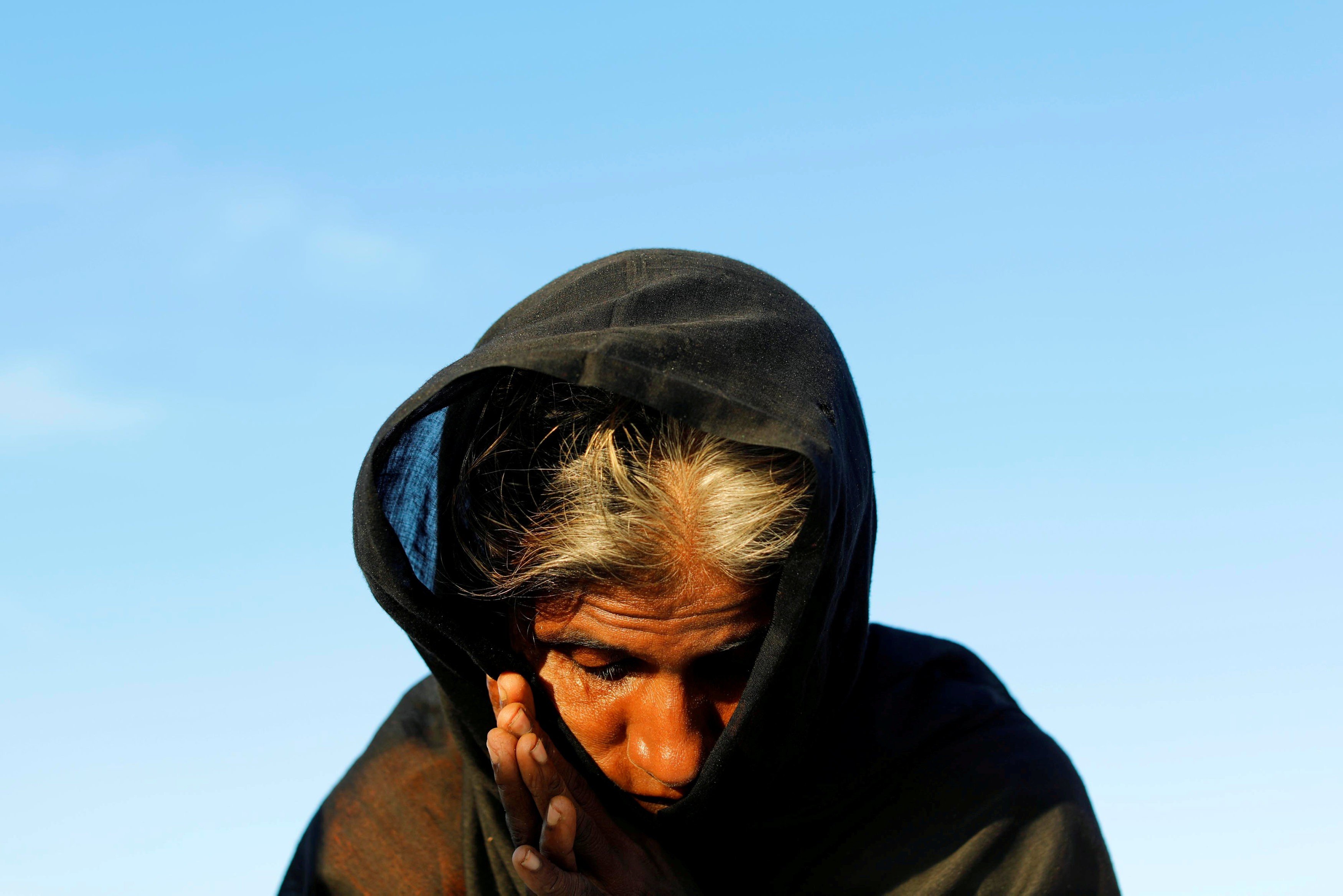 A Rohingya refugee woman waits for permission from the Bangladeshi army to continue, after crossing from Myanmar into Teknaf, Bangladesh, on October 15. Photo: Reuters