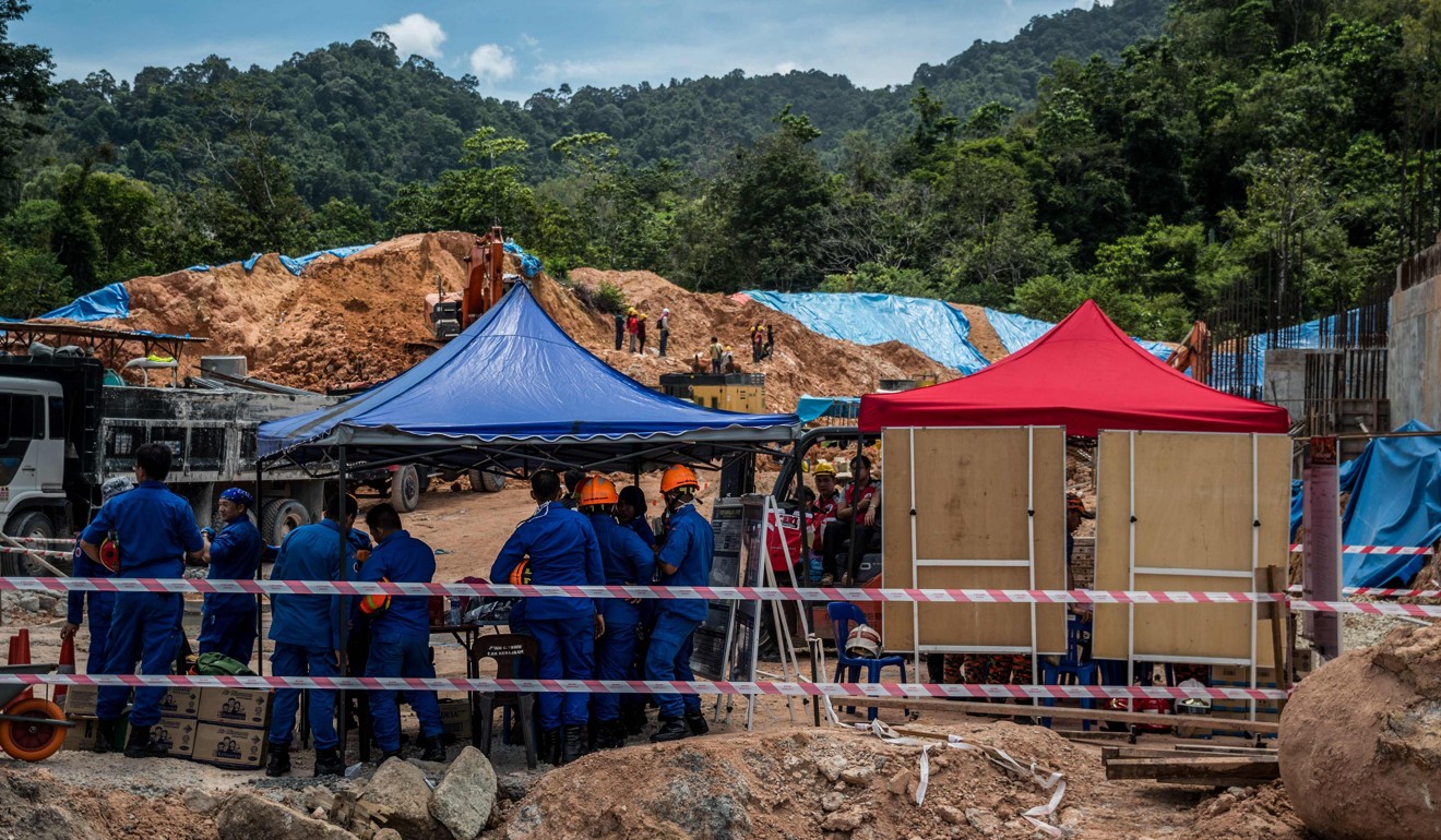 Rescuers search for victims of the landslide at a construction site in Tanjung Bungah, Penang. Photo: AFP