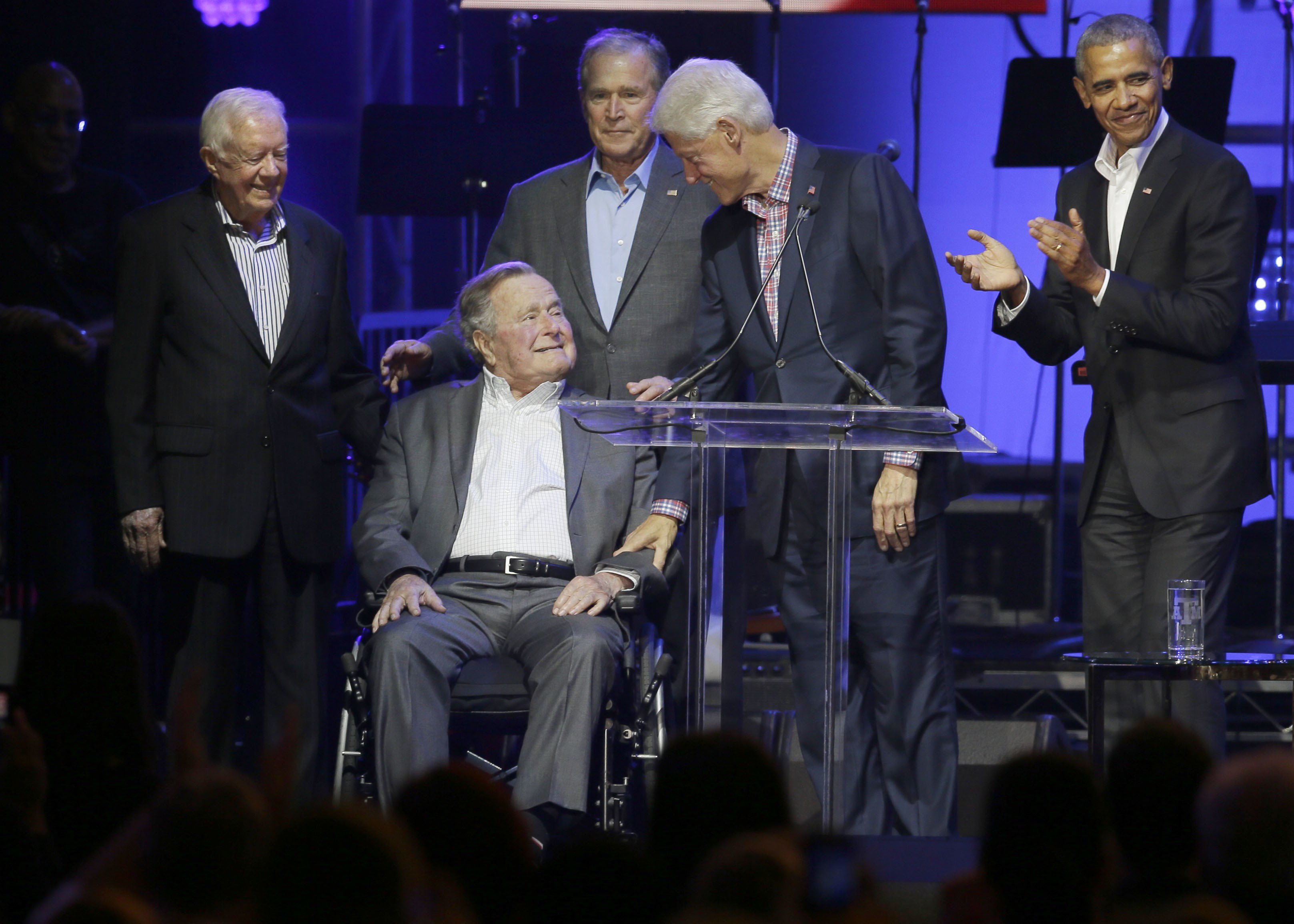 Former presidents from right, Barack Obama, Bill Clinton, George W. Bush, George H.W. Bush and Jimmy Carter gather on stage during a hurricanes relief concert in College Station, Texas. Photo: AP