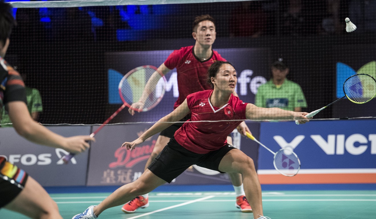 Tse Ying-suet goes for a shot as Tang Chun-man looks on during their victory in Odense. Photo: EPA