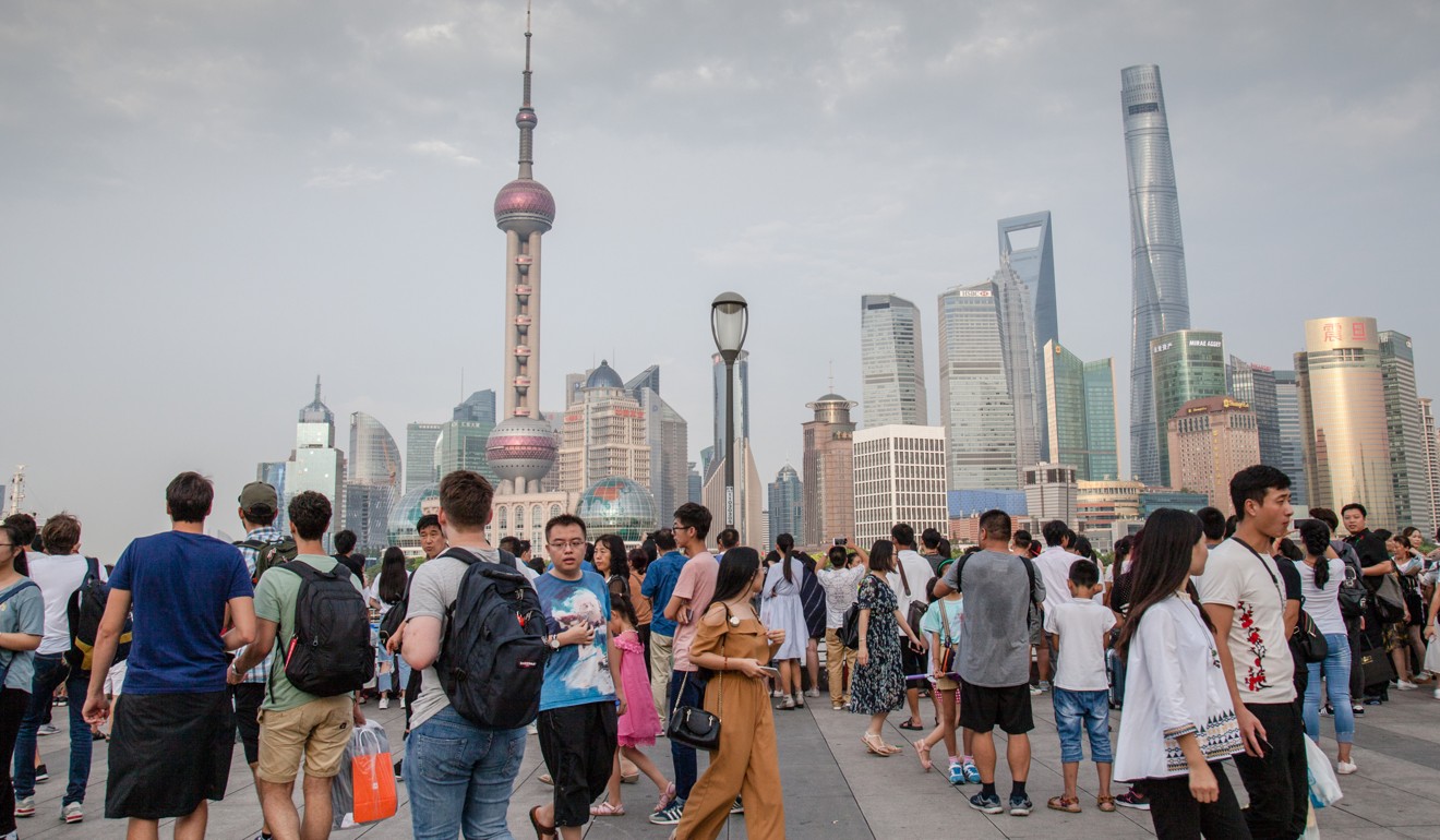 Tourists take in the Shanghai skyline from the Bund. Photo: Valerie Teh
