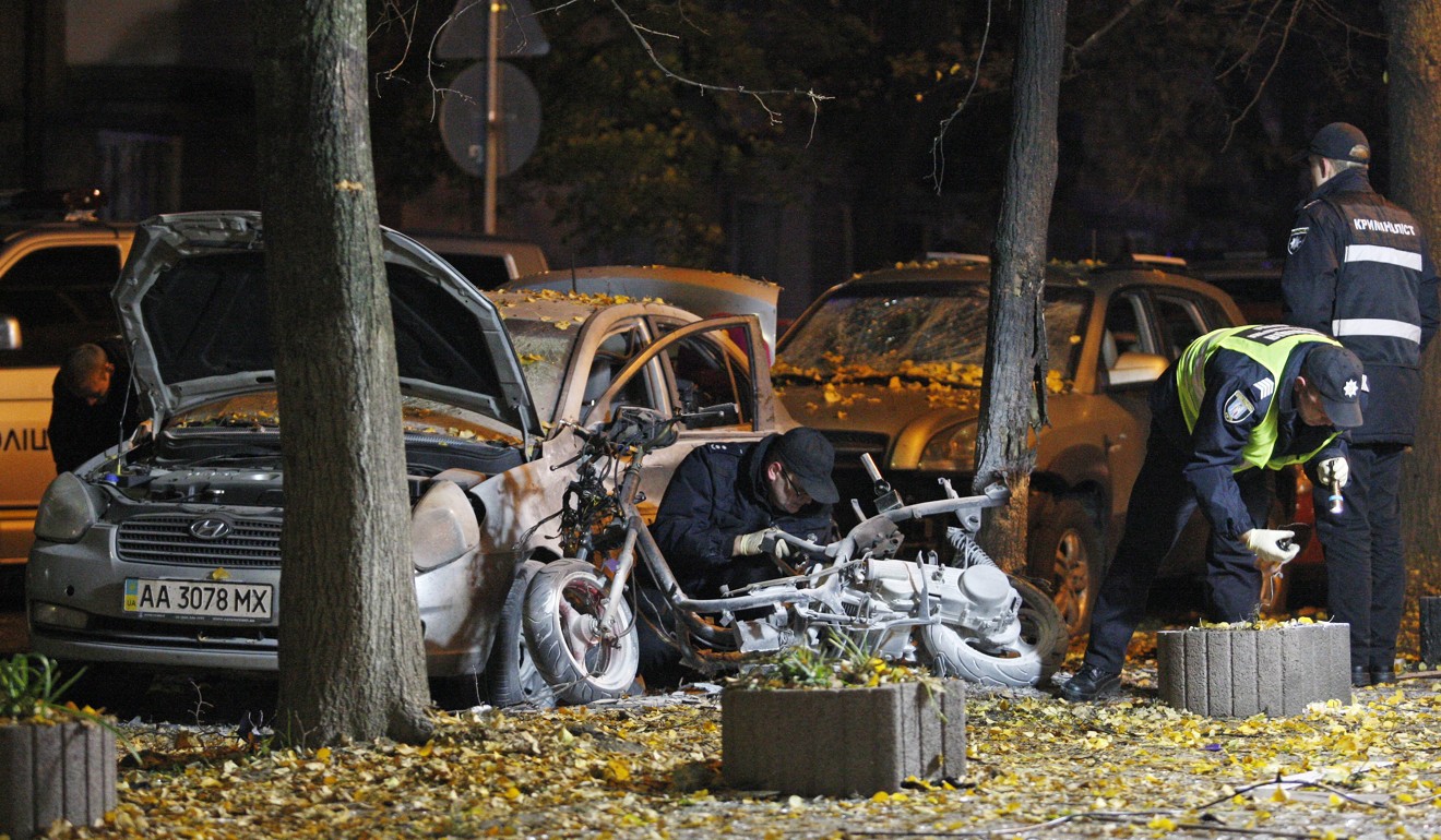 Police examine the scene of the explosion in Kiev late Wednesday. Photo: EPA