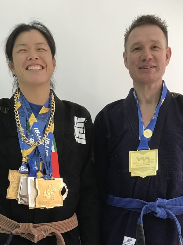 Vasilyev with his medal from the World Master tournament at Viking Wong’s ‘Hurt Locker’ jiu-jitsu studio in Tsim Sha Tsui, alongside Tesa Ho, who also won medals in Las Vegas. Photo: Nicolas Atkin