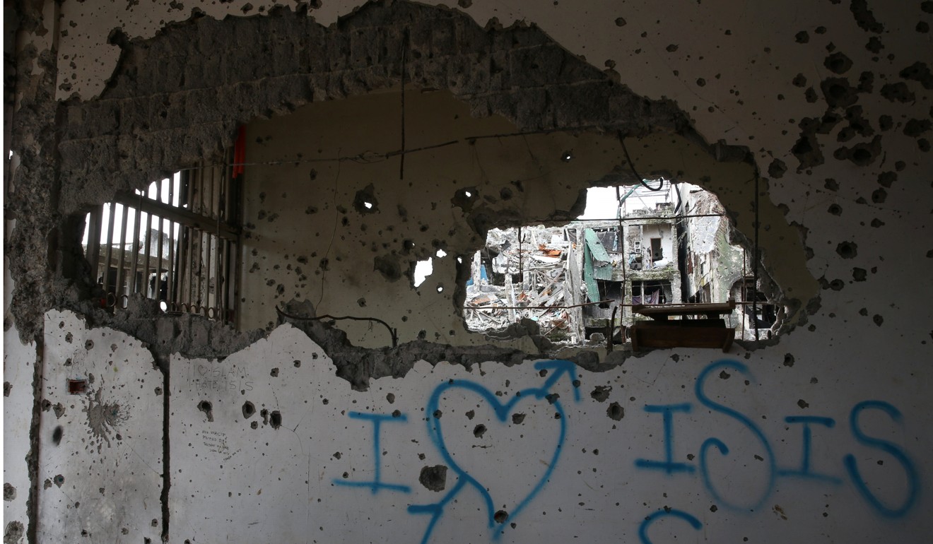 Pro-Islamic State graffiti on a building in Marawi. Photo: Reuters
