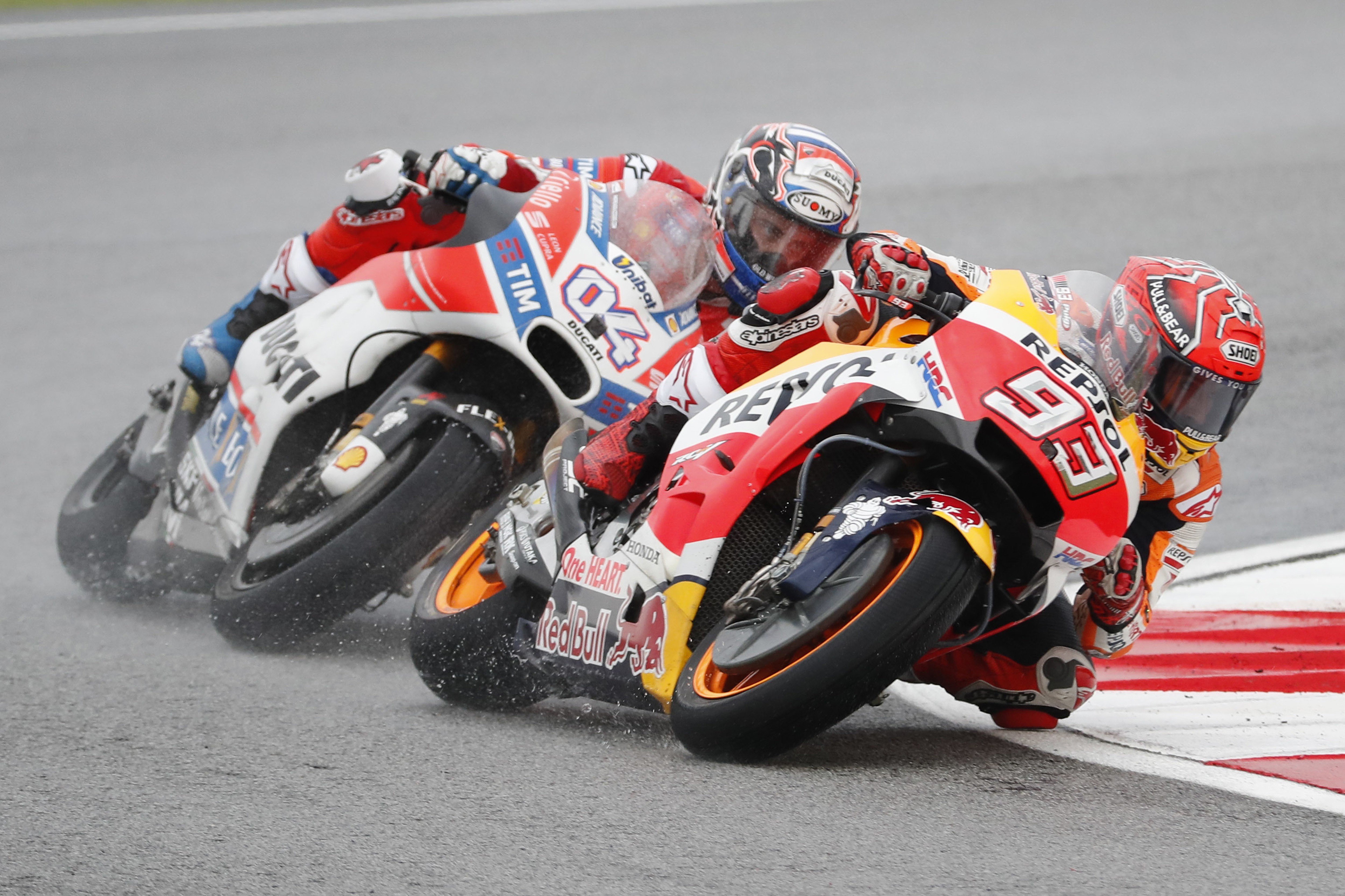 Spain's MotoGP rider Marc Marquez steers his Honda as Italy's MotoGP rider Andrea Dovizioso follows close behind during the Malaysia MotoGP. Photo: AP