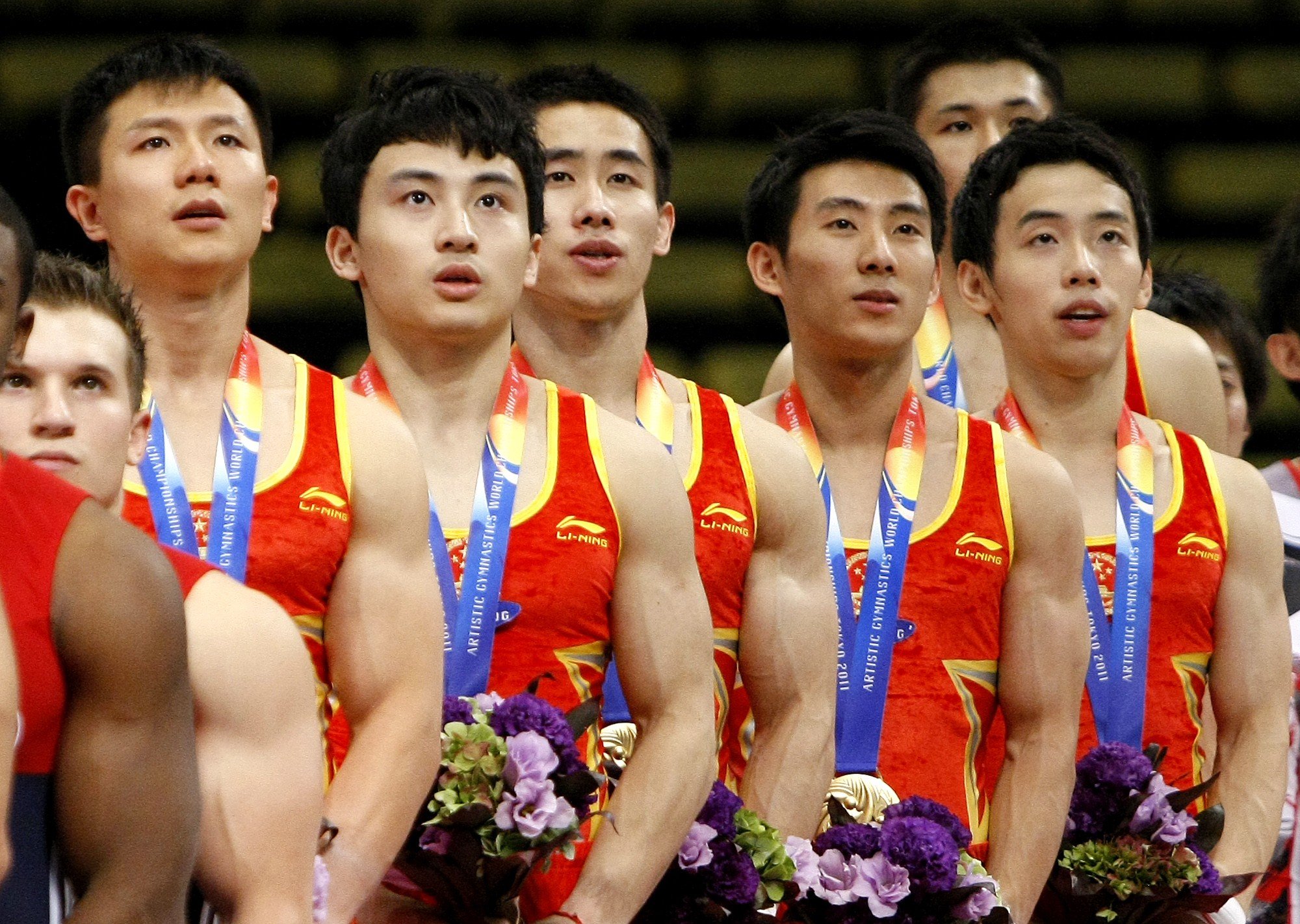Chinese gymnasts sing along as the national anthem is played during the awards ceremony for the men’s team final at the Artistic Gymnastics World Championships in Tokyo in October 2011. Photo: AP