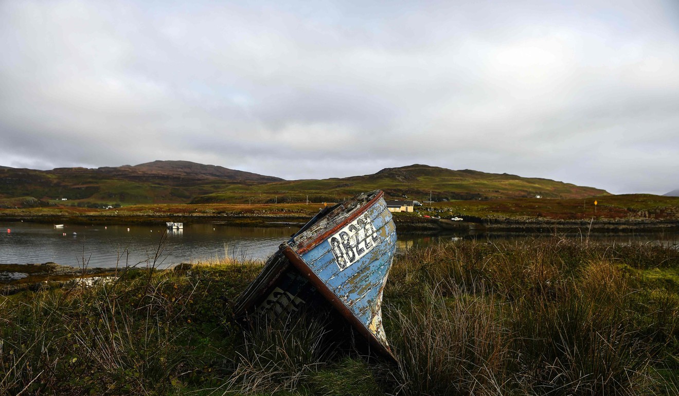 An abandoned boat sits on a grass verge on the Isle of Ulva, off Scotland's west coast. Photo: AFP