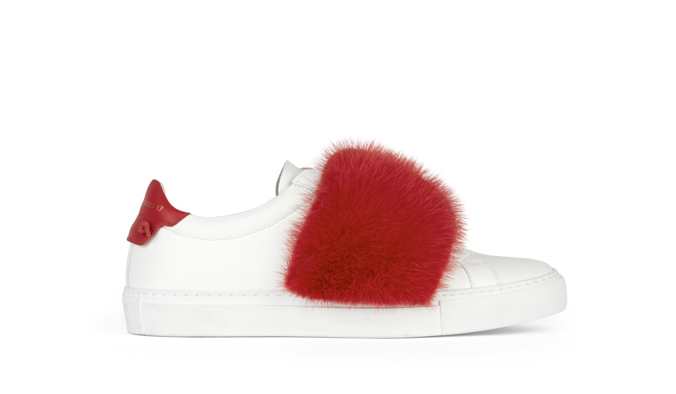 The matte white leather sneakers, with a wide mink band in the iconic Givenchy red, are hip and stylish.