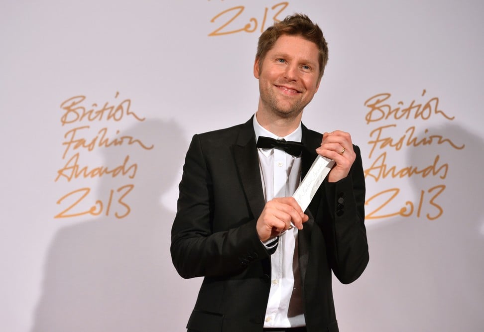 Christopher Bailey, chief creative officer of Burberry, poses with the trophy for Menswear Designer of the Year at the British Fashion Awards in London in 2013. Bailey is stepping down in 2018. Photo: AFP
