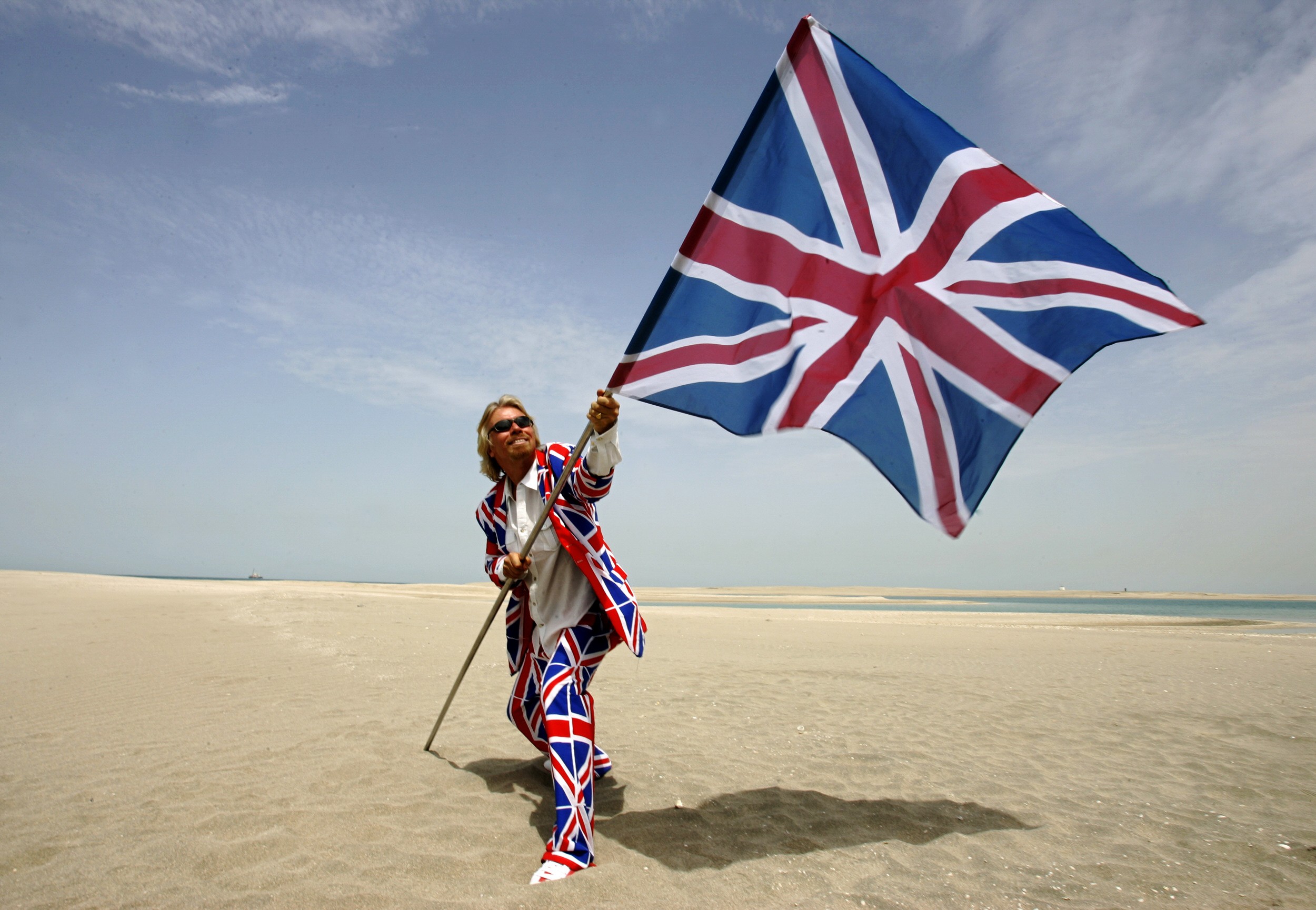 Richard Branson plants a Union flag in the British section of a map-of-the-world-shaped property development in Dubai. Picture: AFP