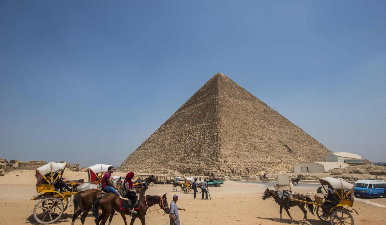 Egyptians riding their carts past the Great Pyramid of Cheops, also known as Khufu’s Pyramid, on the southern outskirts of Cairo. Photo: AFP