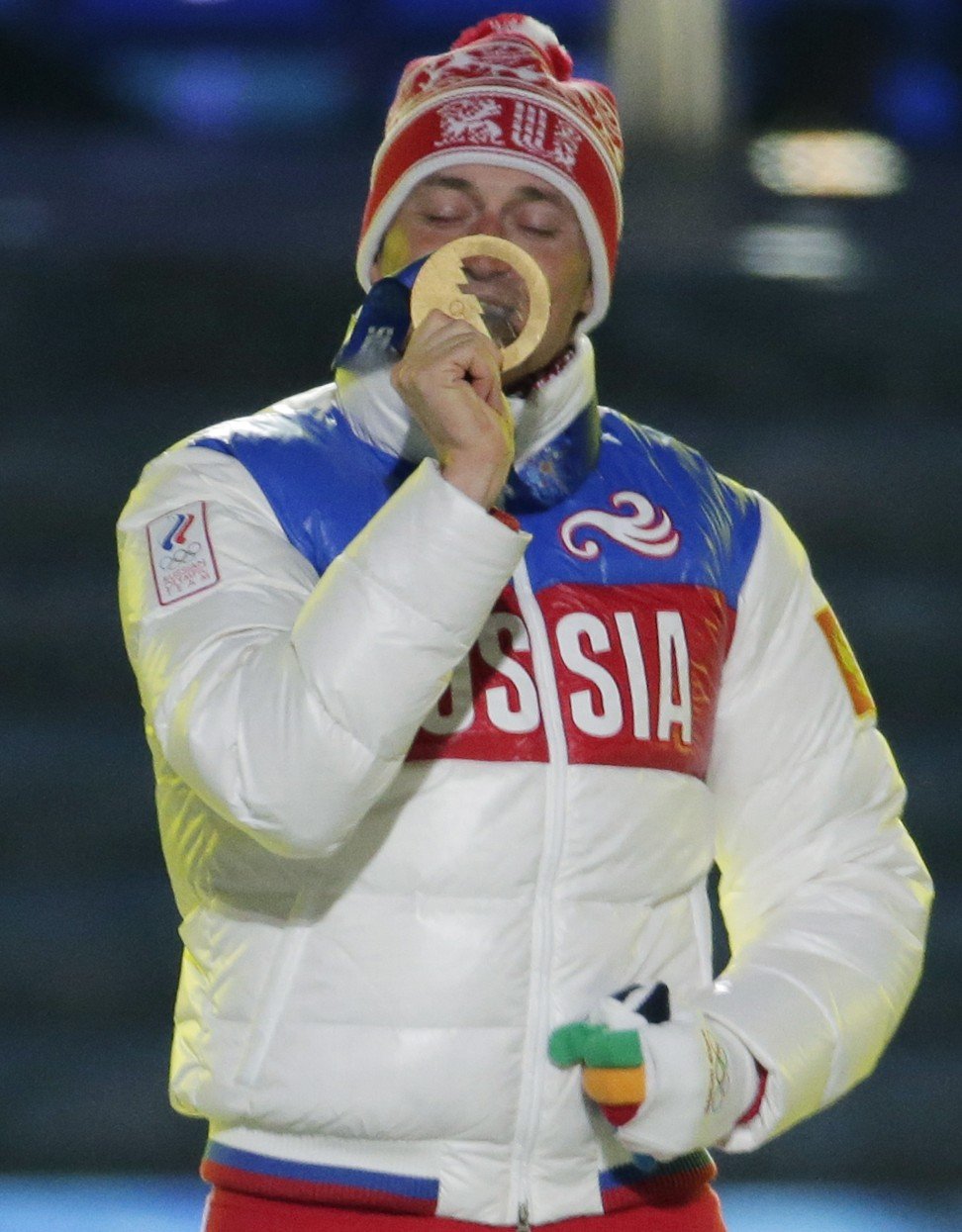 Russia's gold medal winner Alexander Legkov kisses his medal during the medals ceremony for the men's 50km cross-country race at the 2014 Winter Olympics in Sochi. Photo: AP