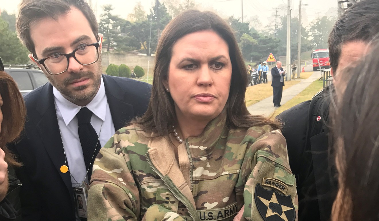 White House Press Secretary Sarah Huckabee Sanders, wearing a borrowed US Army jacket to keep warm, updates reporters on Trump's failed attempt to travel to the DMZ. Photo: Reuters