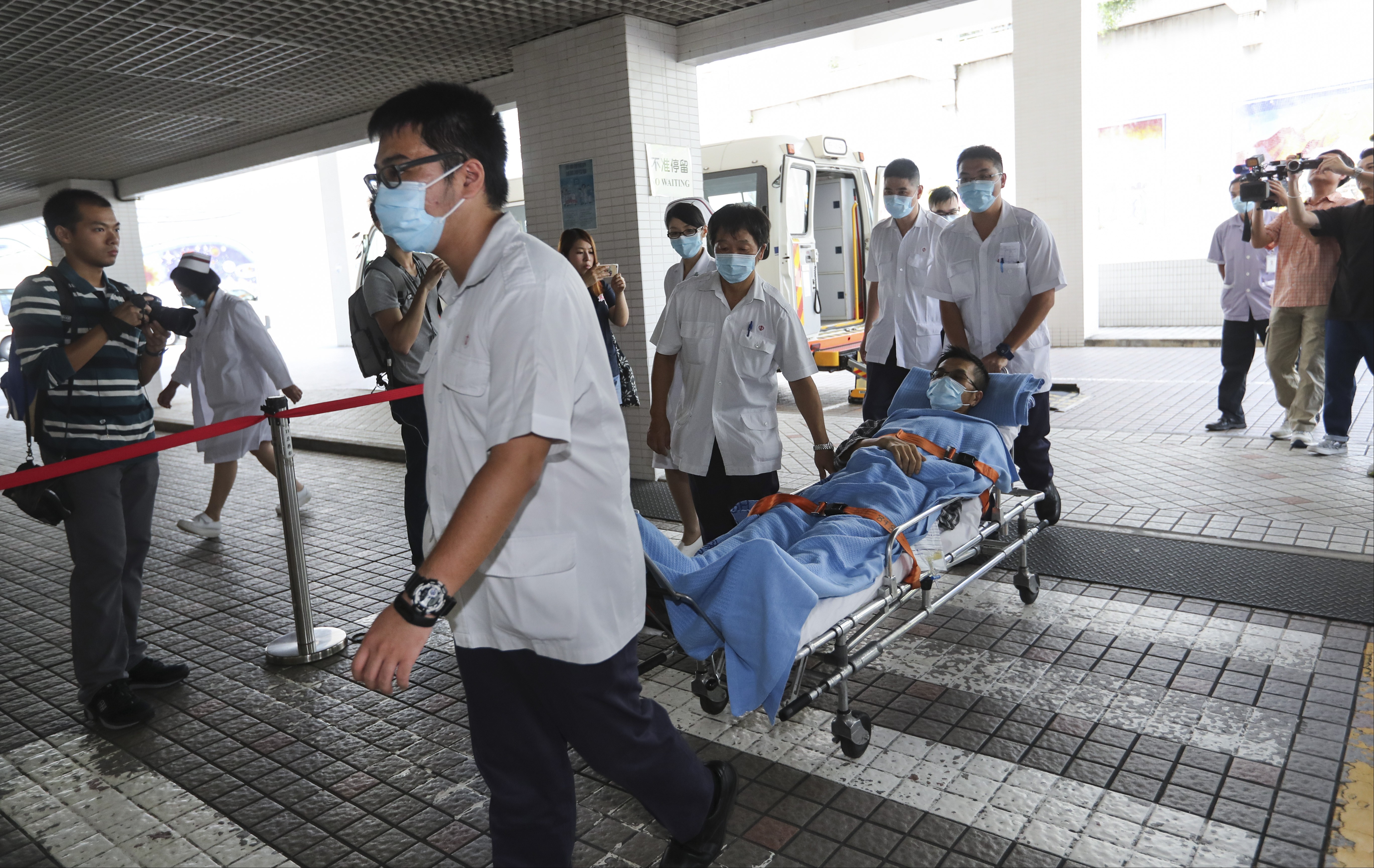 Patients from Queen Elizabeth Hospital are transferred to privately run St Teresa's Hospital in Kowloon City in July as part of a plan to ease overcrowding in the public health sector. Photo: Edward Wong