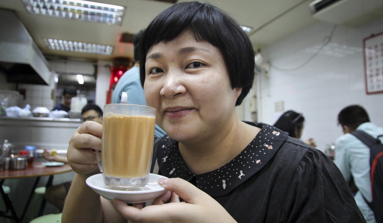 Hong Kong food writer Emily Tong enjoys a Hong Kong-style milk tea at Wai Kee Noodle Cafe in Sham Shui Po. Photo: Alkira Reinfrank