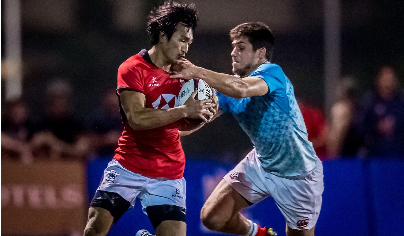 Hong Kong’s try scorer Salom Yiu tries to shrug off a tackle.