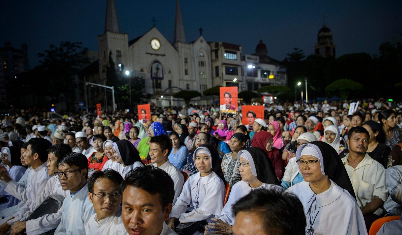 Aung San Suu Kyi's portrait is held aloft during aPrayer for Peace ceremony in Yangon. Photo: AFP