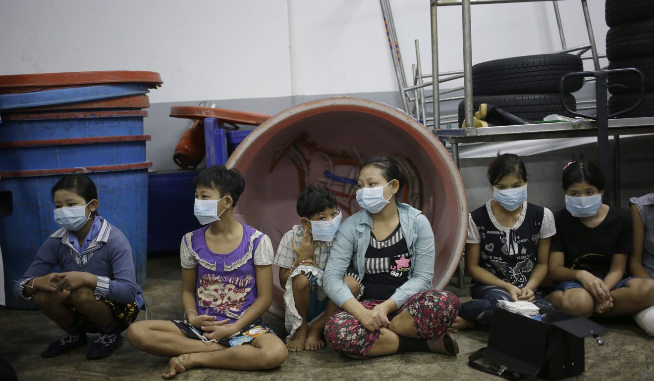 Children sit together to be registered by officials during a raid on a shrimp shed in Samut Sakhon, Thailand, in 2015. An International Labour Organisation report estimated 10,000 migrant children aged 13 to 15 work in the city. Photo: AP