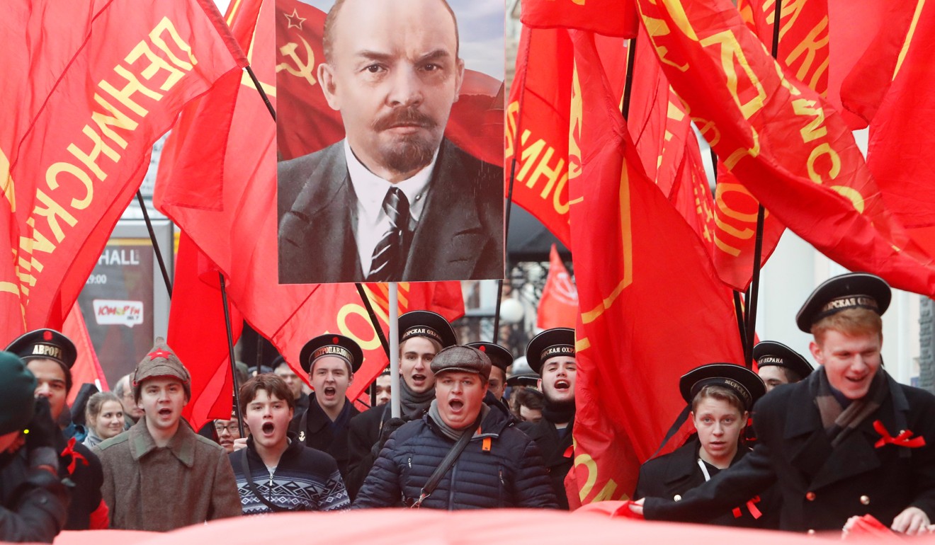 Demonstrators carry flags and a portrait of Soviet founder Vladimir Lenin during a rally held by the Russian Communist Party to mark the revolution's centenary in central Moscow on November 7. Photo: Reuters