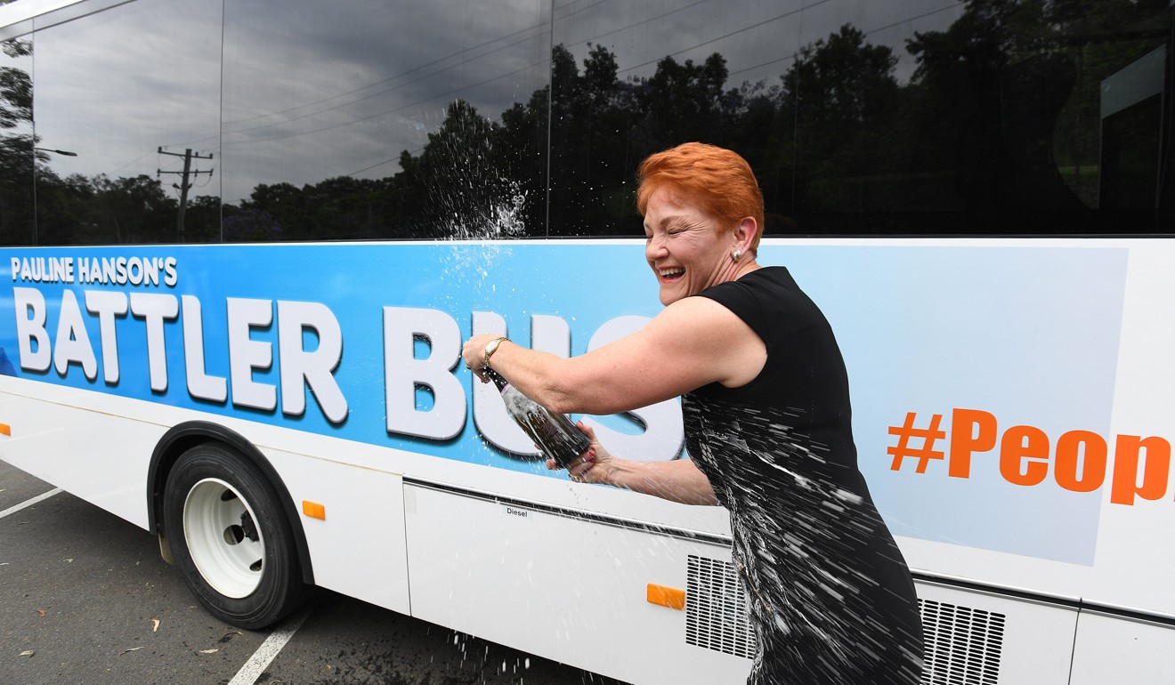 One Nation leader Pauline Hanson pops a bottle of champagne before boarding the One Nation ‘Battler Bus’. Photo: EPA