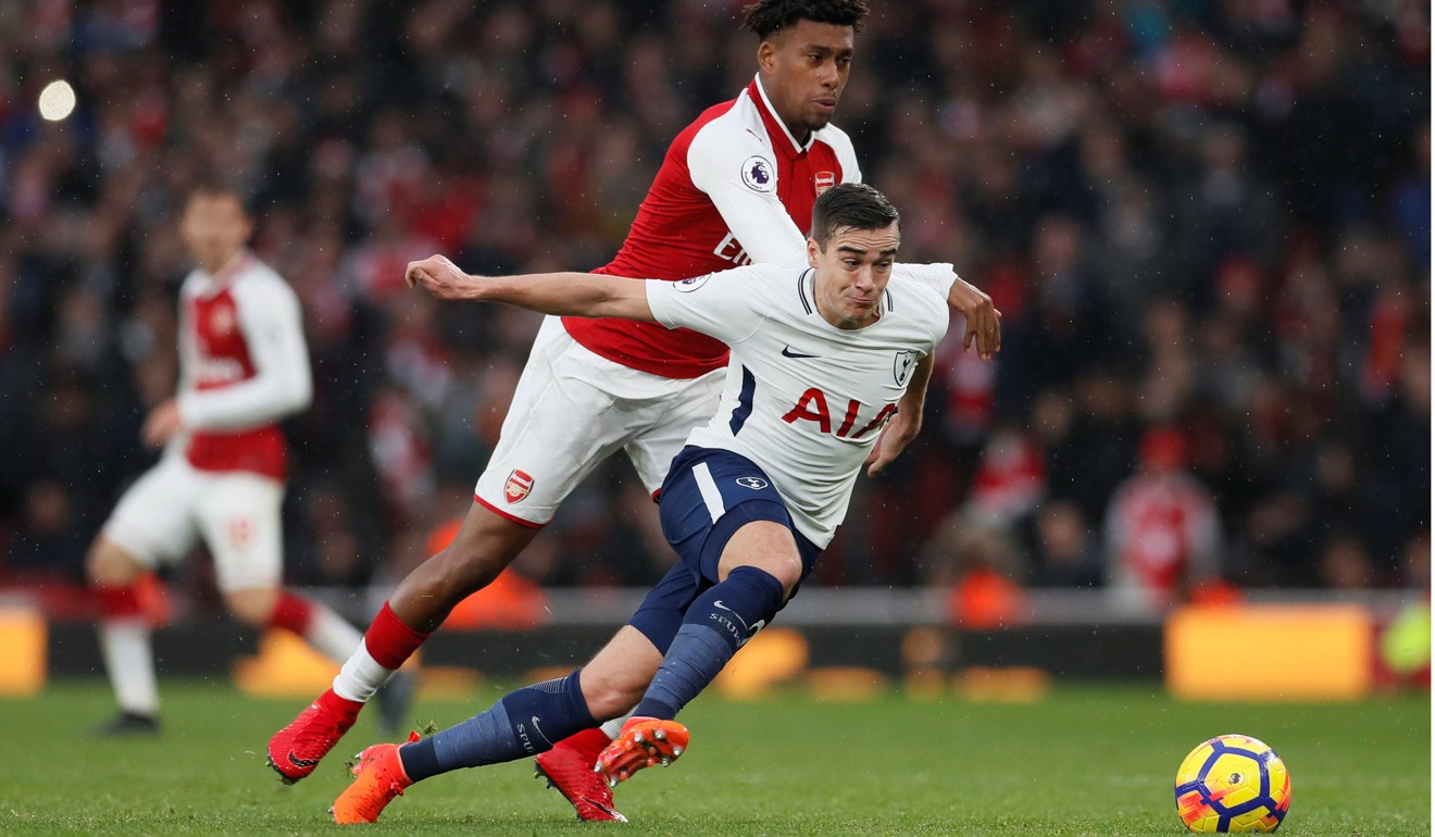 Tottenham's Harry Winks tries to dribble past Arsenal's Alex Iwobi. Photo: Reuters
